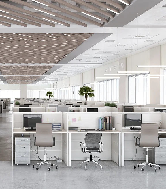 A modern open-plan office with empty desks and workstations
