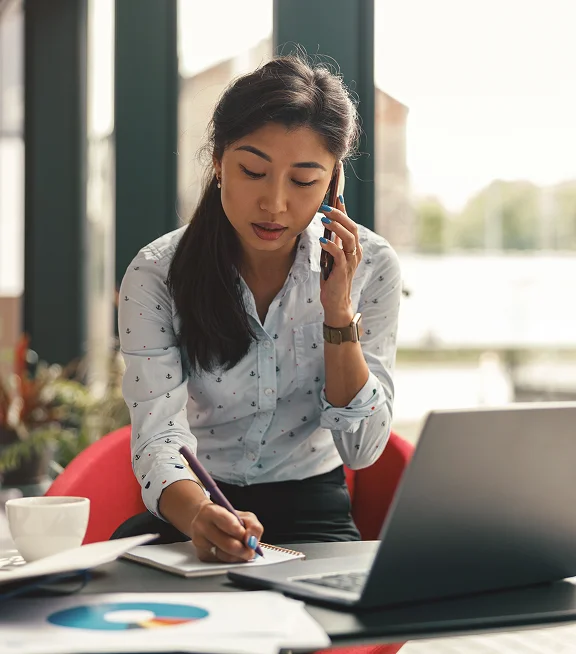 Facilities manager reviewing workplace tasks on a laptop