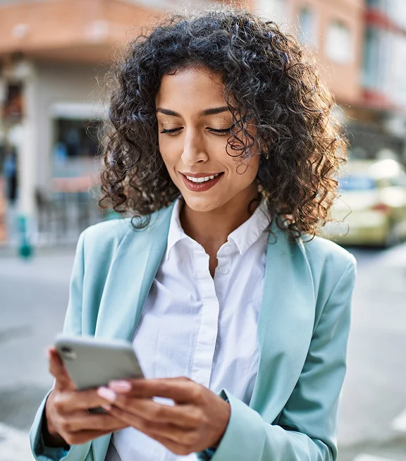An employee using the DeskFlex mobile app on their phone outside the office